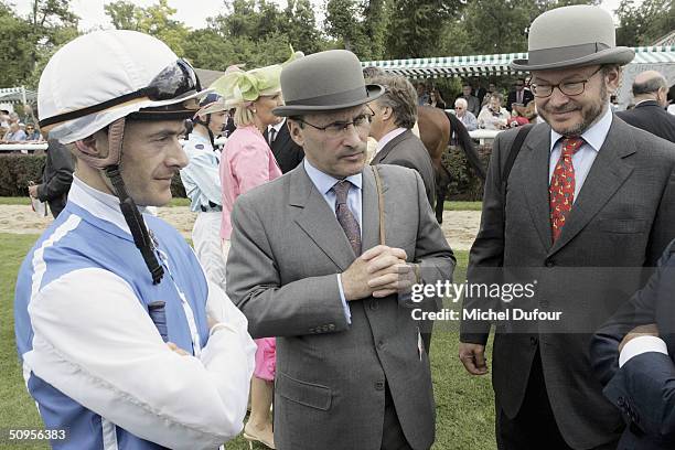 Alain Wertheimer and Gerard Wertheimer, owners of the House of Chanel, with jockey Olivier Peslier attend the Prix de Diane Hermes on June 13, 2004...