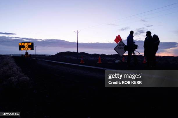 Media wait at a checkpoint about 4 miles from the Malheur Wildlife Refuge Headquarters near Burns, Oregon, on February 11, 2016. - The FBI surrounded...