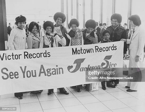 Victor Records presented the Jackson Five family with a banner as they were about to depart Asia after a very successful tour, left to right, Tito,...