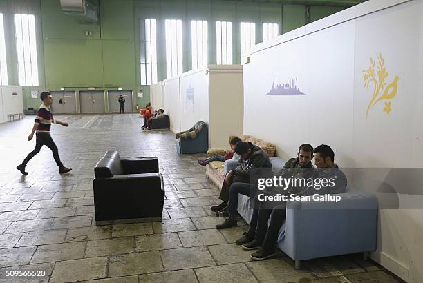 Refugees and migrants seeking asylum in Germany while away time among cubicles that contain bunk beds and offer at least some privacy in Hangar 2 at...