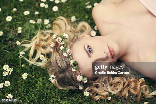 young woman wearing a flower crown in a flowers - pure stock pictures, royalty-free photos & images