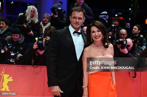 German actress Iris Berben and husband Gabriel Lewy pose for photographers as he arrives on the red carpet for the film "Hail, Caesar!" screening as...
