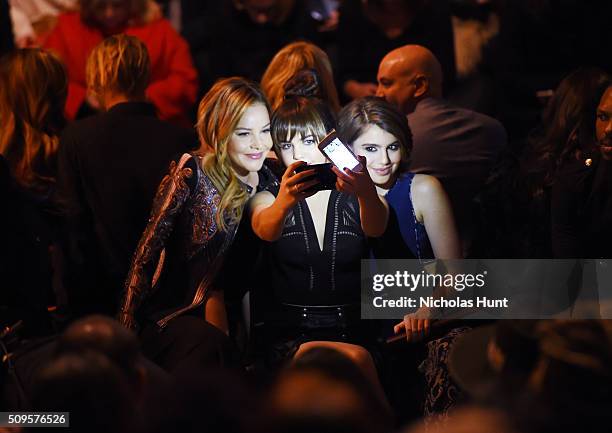 Actresses Abbie Cornish, Bailee Madison and Sami Gayle take a selfie as they attend the front row at the BCBGMAXAZRIA Fall 2016 show during New York...