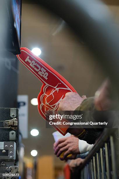 February 9: Attendees wear foam fingers while they wait for Republican presidential candidate Donald Trump to give his victory speech after winning...