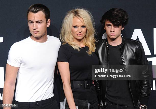 Brandon Lee, Pamela Anderson and Dylan Lee attend the Saint Laurent show at The Hollywood Palladium on February 10, 2016 in Los Angeles, California.