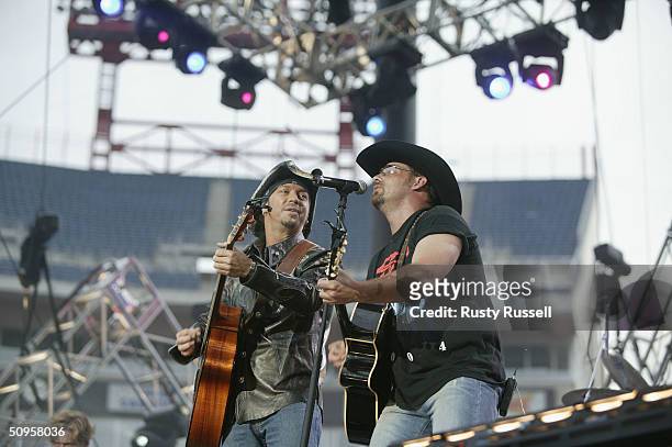 Bret Michaels of Poison performs with country music artist Chris Cagle at the 2004 CMA Music Festival June 13, 2004 in Nashville, Tenessee. The...