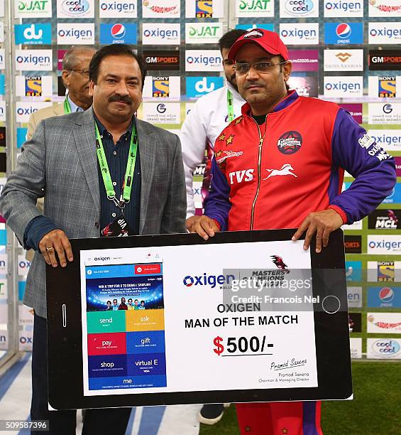 Virender Sehwag of Gemini Arabians receives the Man of the Match award after the Oxigen Masters Champions League Semi Final match between Gemini...