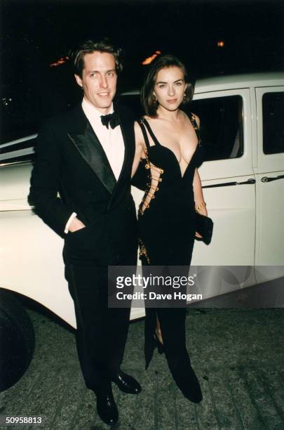 British actor Hugh Grant and his girlfriend Elizabeth Hurley attend the premiere of Grant's latest film, 'Four Weddings and a Funeral' in London,...