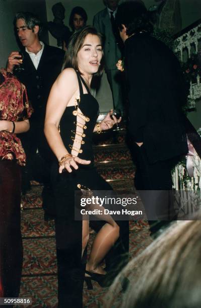 British actress Elizabeth Hurley attends the London post-premiere party of her boyfriend Hugh Grant's latest film, 'Four Weddings and a Funeral'...