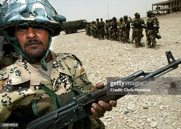 A recruit with the Iraqi Civil Defense Corps stands in formation June