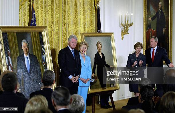 Former US President Bill Clinton and Senator Hillary Clinton stand by their offical White House portraits during the unveiling event hosted by...