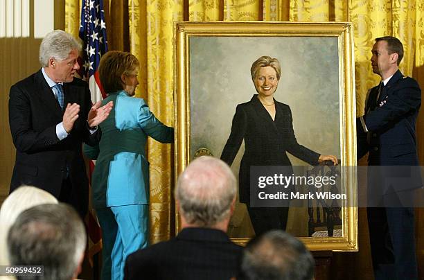 Former U.S. President Bill Clinton and his wife U.S. Senator Hillary Clinton look at Hillary's portrait during a ceremony to unveil Clinton portraits...