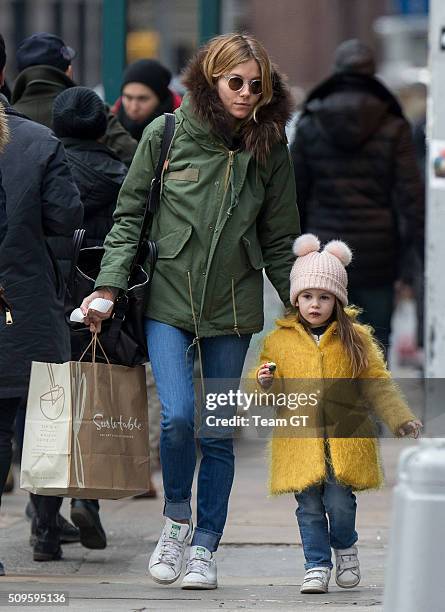 Sienna Miller stopping to get her daughter a cupcake while taking a walk through Soho on February 09, 2016 in New York City.