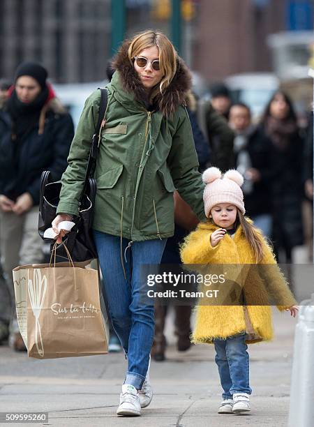 Sienna Miller stopping to get her daughter a cupcake while taking a walk through Soho on February 09, 2016 in New York City.