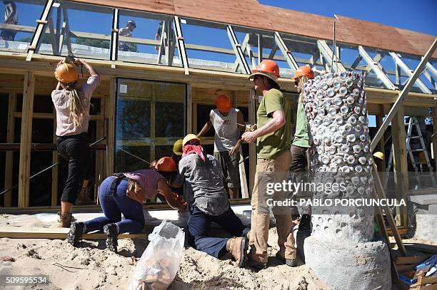 Trainees work during the construction of an auto-sustainable elementary school in Jaureguiberry -80 km east of Montevideo, Uruguay- on February 11,...