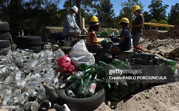 Trainees work during the construction of an auto-sustainable elementary school in Jaureguiberry -80 km east of Montevideo, Uruguay- on February 11,...