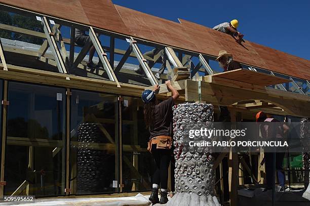 Trainees work during the construction of an auto-sustainable elementary school in Jaureguiberry -80 km east of Montevideo, Uruguay- on February 11,...