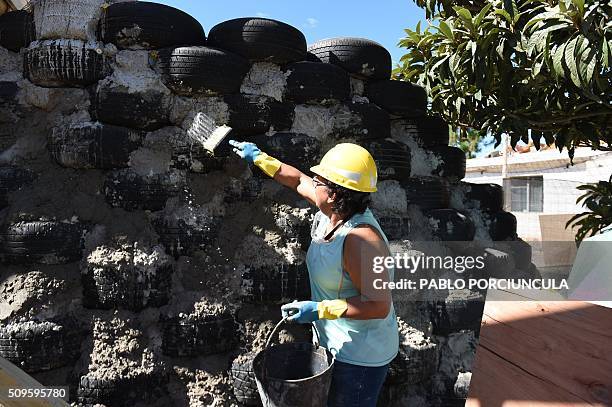 Trainees work during the construction of an auto-sustainable elementary school in Jaureguiberry -80 km east of Montevideo, Uruguay- on February 11,...