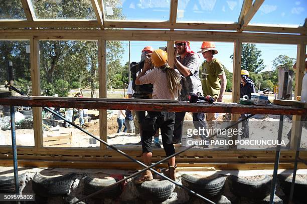 Trainees work during the construction of an auto-sustainable elementary school in Jaureguiberry -80 km east of Montevideo, Uruguay- on February 11,...