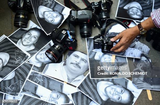 View of photos of killed journalists and cameras outside the Veracruz state representation office during a journalists protest in Mexico City on...