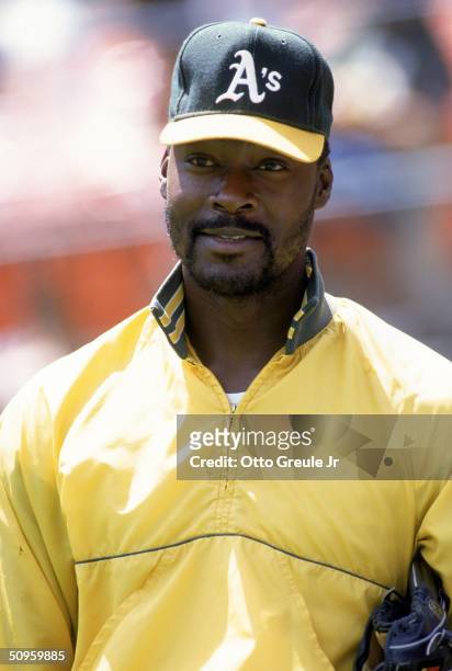 Pitcher Dave Stewart of the Oakland Athletics stand on the field before a game during the 1990 season at Oakland Alameda County Stadium in Oakland,...
