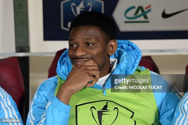 Marseille's French midfielder Abou Diaby reacts on the bench of substitutes during the French Cup football match Trelissac vs Marseille on February...