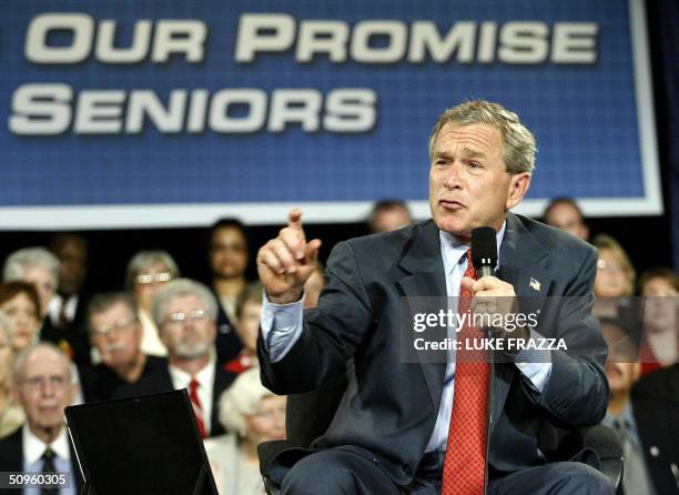 President George W. Bush participates in a conversation on Medicare-approved prescription drug discount cards 14 June 2004 at the Liberty Community...