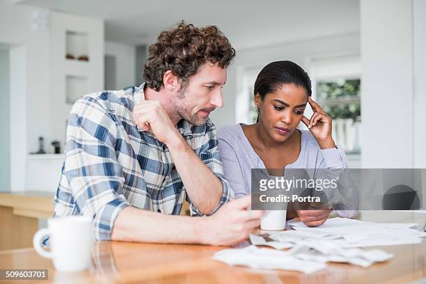 tensed couple reading bills - worry bildbanksfoton och bilder