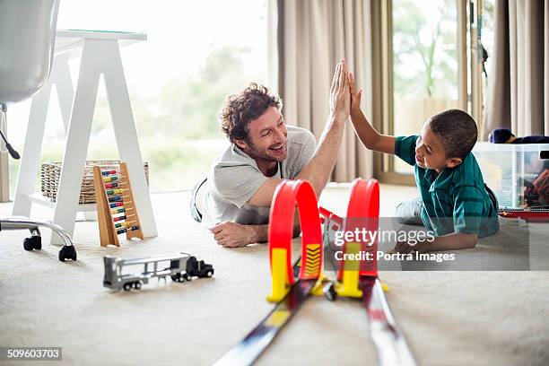 happy father and son while playing games - 子供　おもちゃ ストックフォトと画像