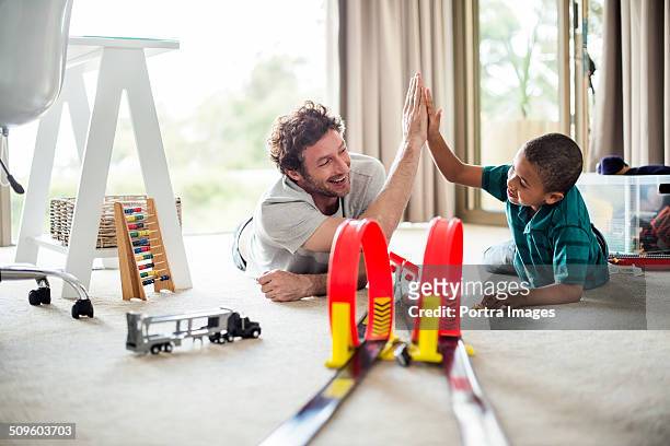happy father and son while playing games - playing toy men stockfoto's en -beelden
