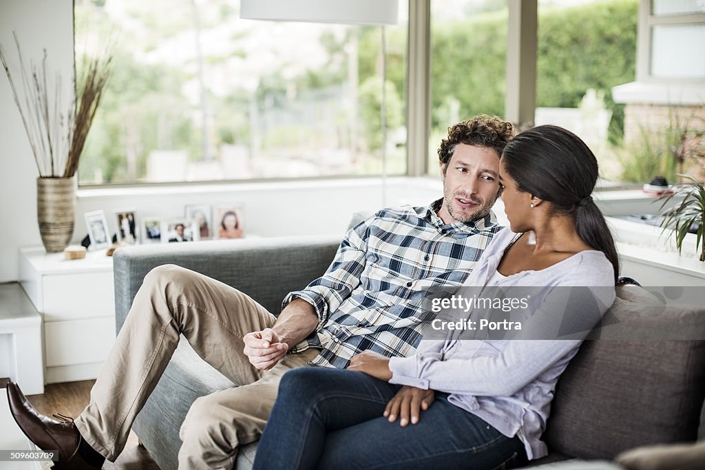 Couple relaxing on sofa at home