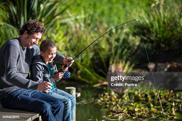 family fishing in pond - kids fishing stock pictures, royalty-free photos & images