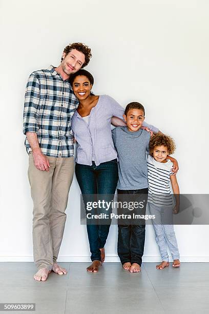 portrait of family standing together at home - famiglia con due figli foto e immagini stock