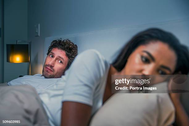 sad woman ignoring man at home - bed conflict stock pictures, royalty-free photos & images