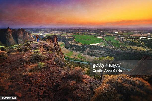 woman in blue dress stands on edge of plateau at smith rock summit at sunset, oregon - smith rock state park bildbanksfoton och bilder