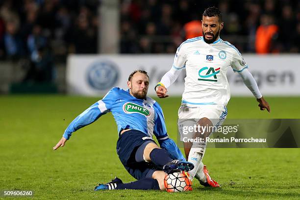 Jacques-Alaixys Romao of Olympique de Marseille is tackled byJimmy Burgho of Trelissac FC during the French Cup match between Trelissac FC and...