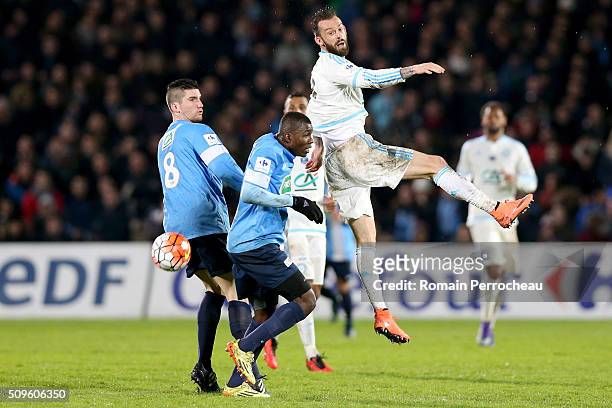 Steven Fletcher of Olympique de Marseille battle for the ball with Ange Negus Gnaleko and Jordane Chevalier of Trelissac FC during the French Cup...