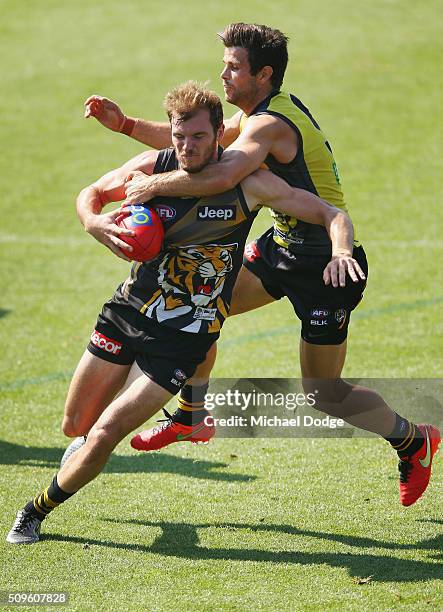 Trent Cotchin of the Tigers tackles high Kamdyn McIntosh of the Tigers during the Richmond Tigers AFL intra-club match at Punt Road Oval on February...