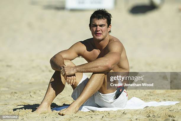 Chris Tarrant of Collingwood relaxes on the beach during a team recovery session at Mooloolaba Beach on the Sunshine Coast June 15, 2004 in...