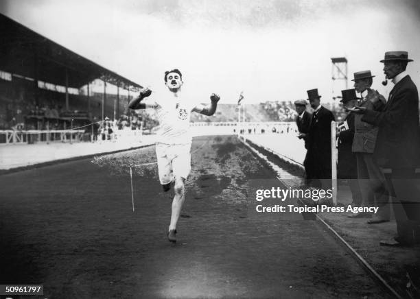 British athlete Wyndham Halswelle crosses the finishing line of the re-run Olympic 400 Metres final at White City, 25th July 1908. Halswelle was the...