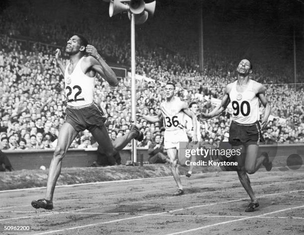Jamaican athlete Arthur Wint equalling the world record to win Olympic gold in the 400 metres event at Wembley Stadium in London, August 1948. Fellow...