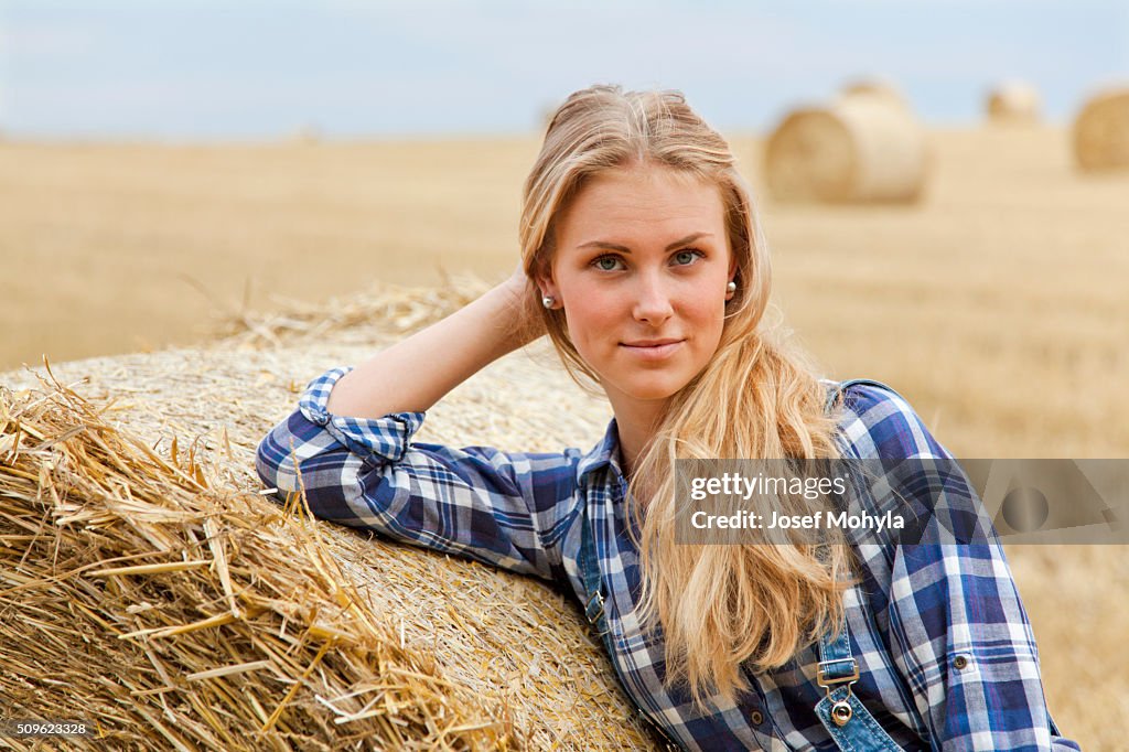 Beautiful young farmer on field