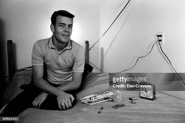 American student Randy Gardner sits on a bed next to various household object he will later have to identify by memory as part of a sleep deprivation...
