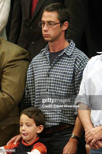 Gilad Sharon, son of Israeli Prime Minister Ariel Sharon, stands with his son during the opening session of the 16th Knesset, Israeli parliament on...