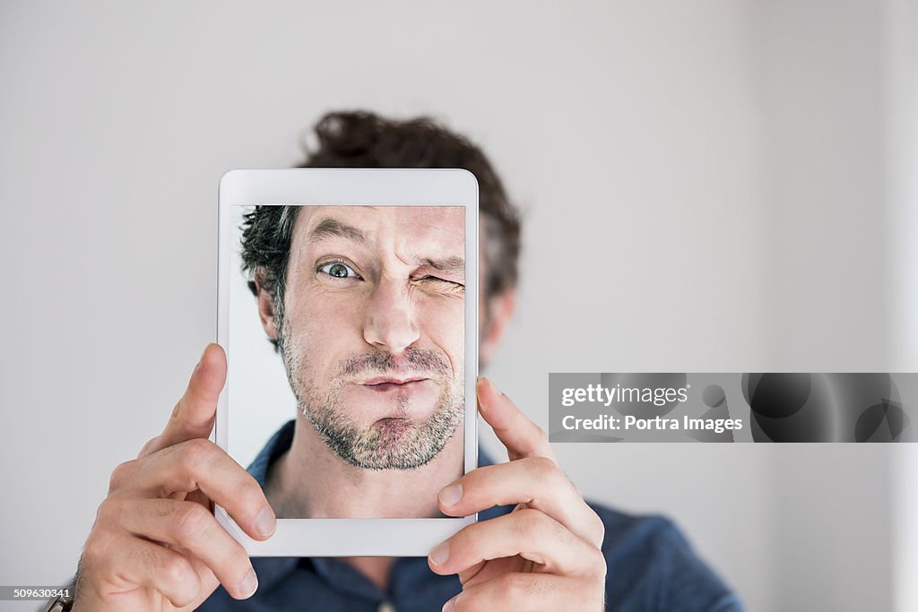 Playful man taking self portrait