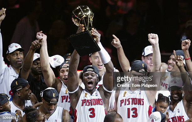 Ben Wallace of the Detroit Pistons holds up the Larry O'Brien NBA Championship trophy as he celebrates with teammatesafter defeating the Los Angeles...