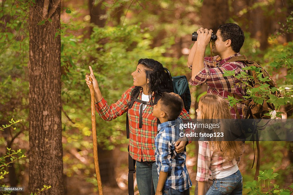 Multi-ethnic family hiking, backpacking outdoors in national park area.