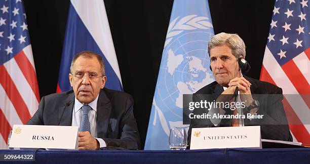 Secretary of State John Kerry listens to Russian Foreign Minister Sergey Lavrov during a press conference following a meeting of the International...