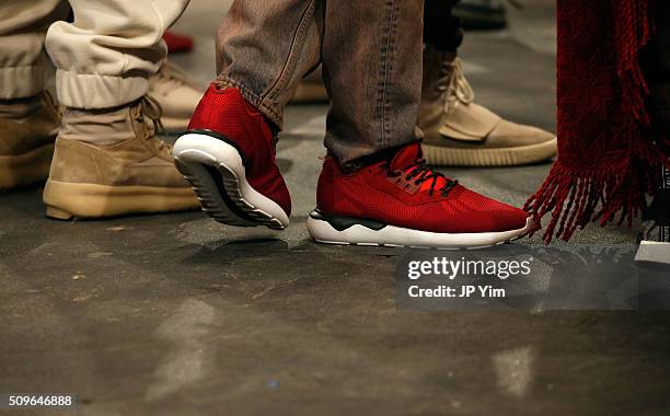 Models, show detail, pose wearing Addidas Yeezy Boost shoes during Kanye West Yeezy Season 3 on February 11, 2016 in New York City.