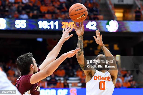 Michael Gbinije of the Syracuse Orange shoots the ball against the defense of Boris Bojanovsky of the Florida State Seminoles during the second half...